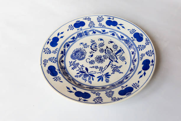 istock a white round plate with floral and line pattern on white background 1127963786
