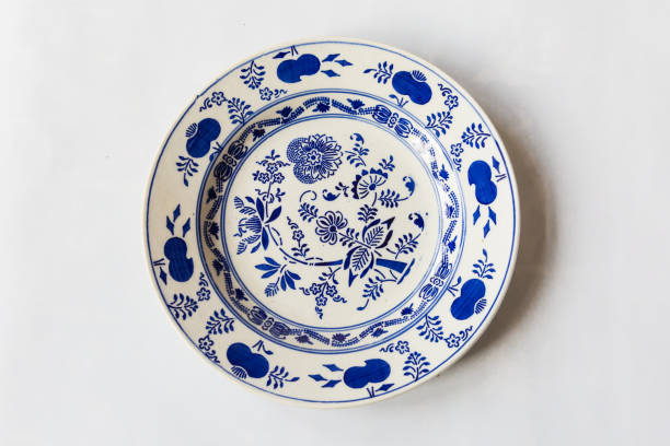 istock a white round plate with floral and line pattern on white background 1127963805