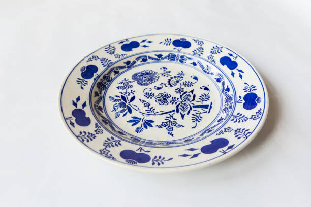 istock a white round plate with floral and line pattern on white background 1127963891