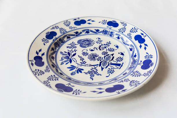 istock a white round plate with floral and line pattern on white background 1127963900