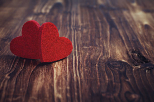 istock Valentines day background with two hearts on wooden background 1127964348