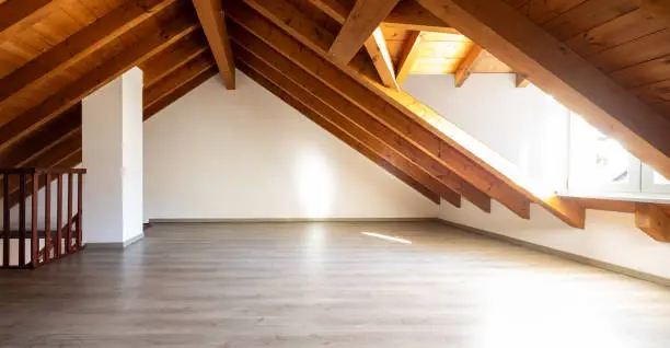 Bright attic with wooden beams and parquet. Nobody inside