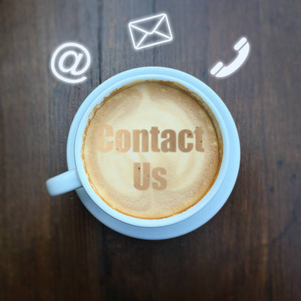istock Contact us coffee office desk table support corporate service information 1127965690