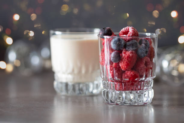 istock Frozen raspberries in glass and yogurt 1127965981