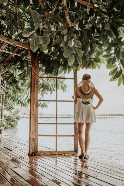 istock Woman walking in the rainforest 1127968129