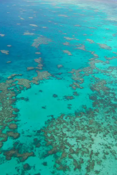 Great Barrier Reef Australia aerial photo with deep blues and turquoise colours. Off the coast of Queensland in northeastern Australia