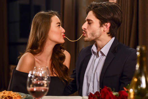 istock Loving couple eating spaghetti 1127969719