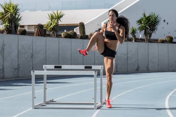 istock young and athletic woman training on athletics track 1127969740