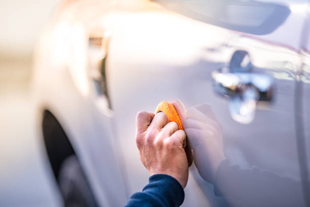 istock Mature man polishing car with applicator pad 1127970137