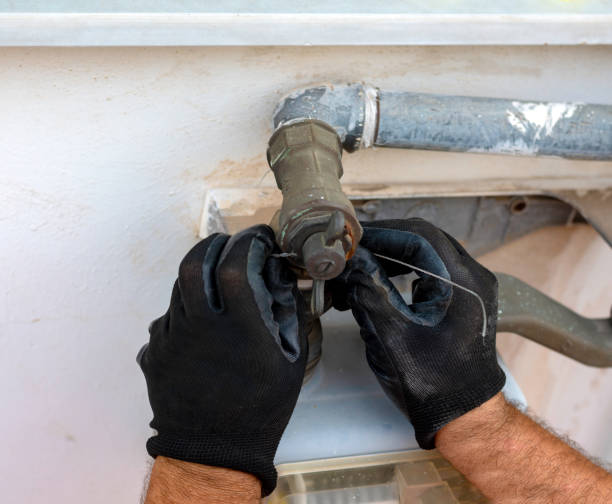 istock Worker removes the seals to the fitting between the pipe and gas meter. Selective focus 1127970746
