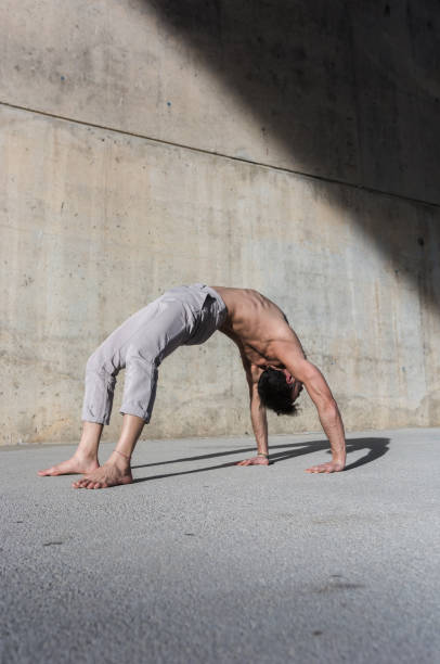 istock Man performing advanced yoga exercises and stretching. 1127971123