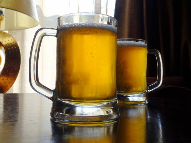 istock Two full mugs of craft beer on the table at pub 1127971259