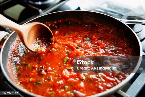 istock Preparing fresh tomato sauce in a domestic kitchen. 1127973172