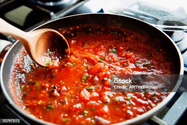 Preparing Fresh Tomato Sauce In A Domestic Kitchen Stock Photo - Download Image Now