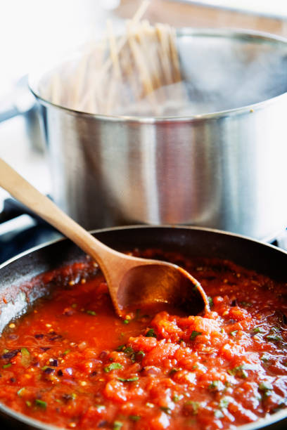 istock Preparing fresh tomato sauce in a domestic kitchen. 1127973197