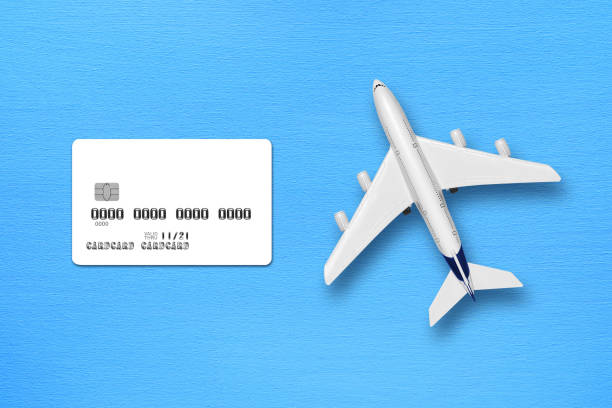 istock Credit card mock-up and toy airplane on blue table top view 1127973380