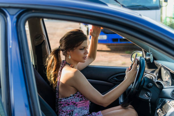 istock Driver Woman Looking at Mobile Phone in the Car. 1127973571