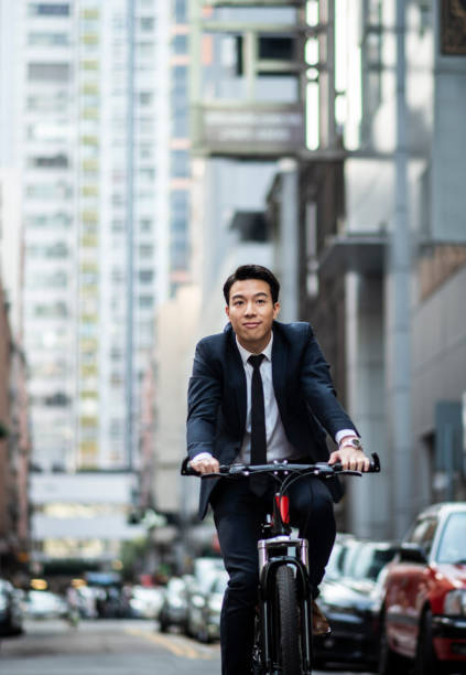 istock Chinese businessman riding to work with his bicycle 1127975188