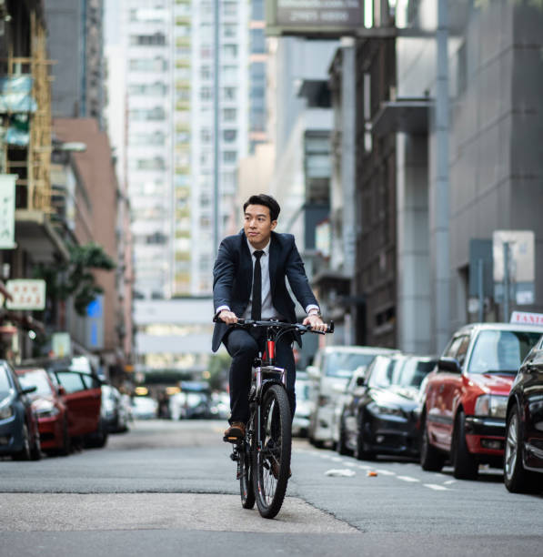 istock Chinese businessman riding to work with his bicycle 1127975196