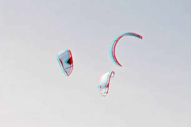Photo of Group of colorful kites of kiteboarding is flying in the blue sky