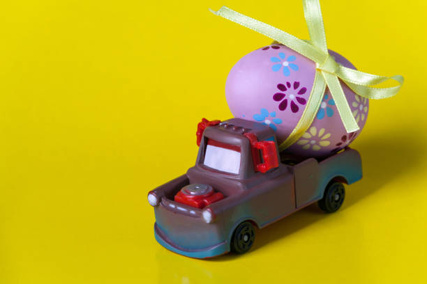 istock Easter egg on the car a yellow background 1127977072