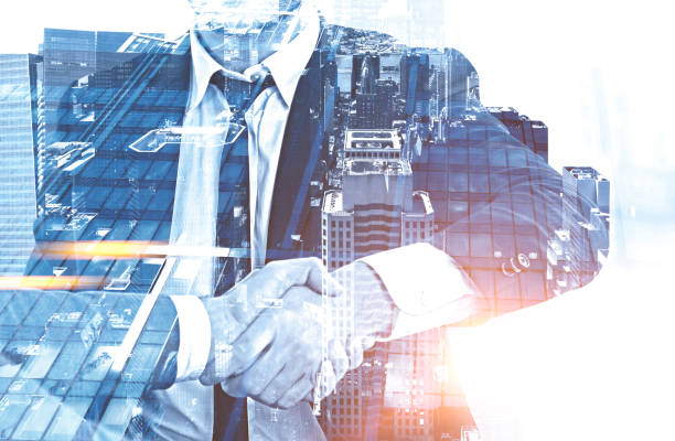 istock Businessmen shaking hands, gray city 1127977204