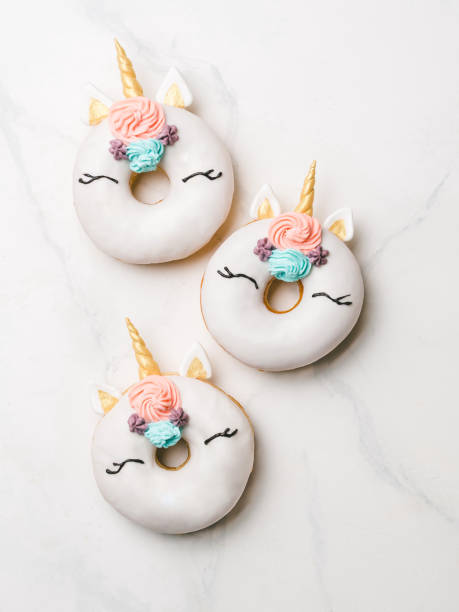 istock Unicorn donuts on white marble background 1127978114