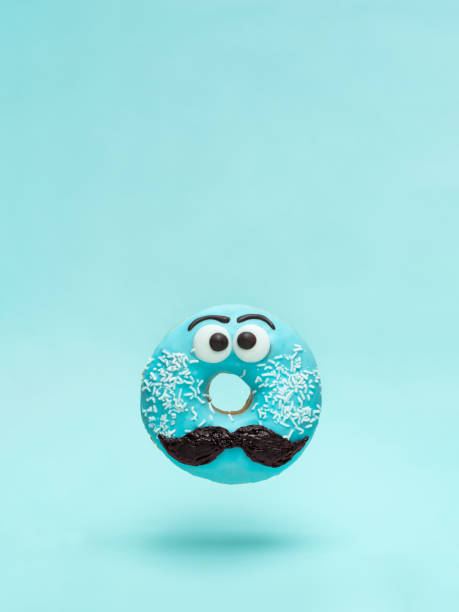 istock Blue glazed donut with mustache flying 1127978316