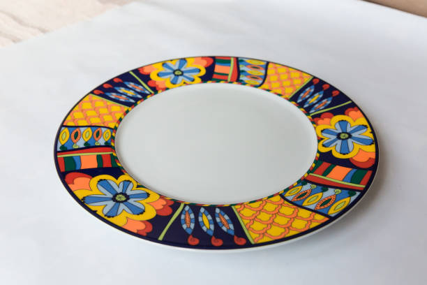 istock a white round plate with floral and line pattern on white background 1127978705