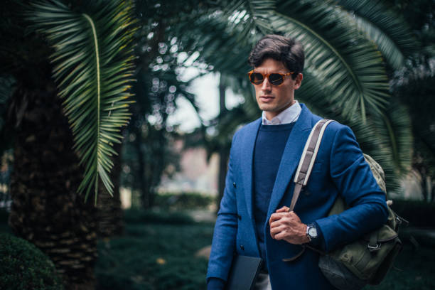 istock Businessman walking in the park 1127980541