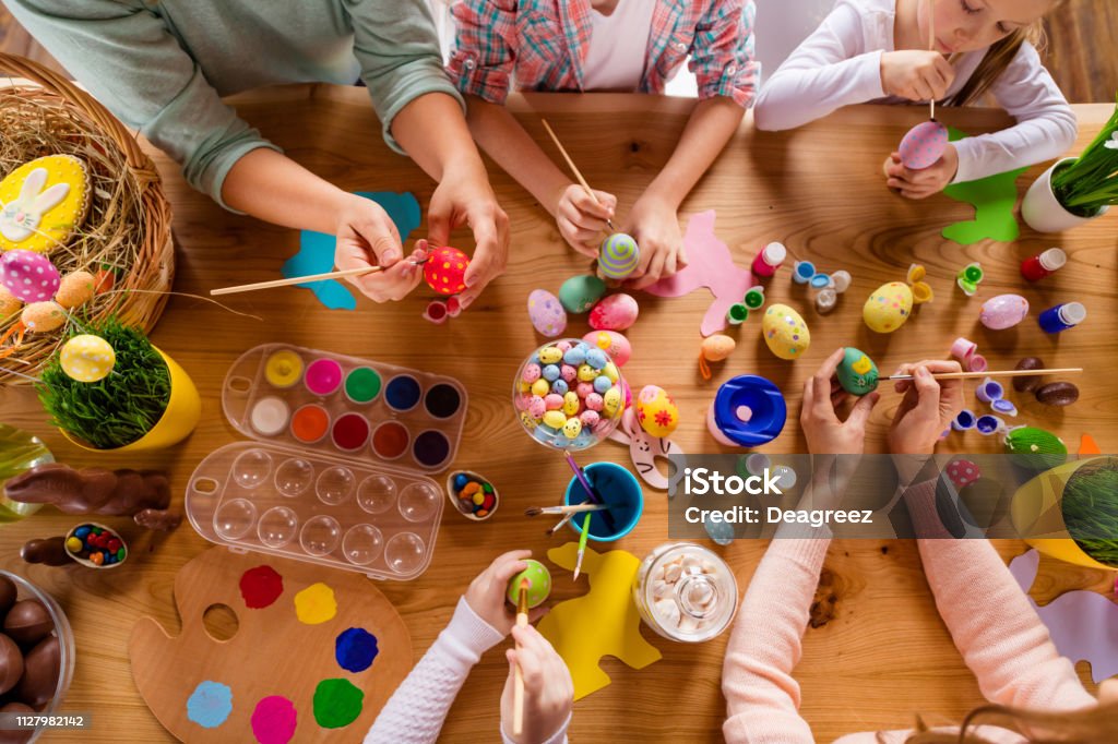 Top above high angle view of work place table nice group of people hands doing making decor accessory things classes courses studying in house indoors Easter Stock Photo