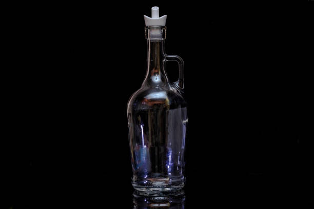 istock glass bottle on black background 1127983490