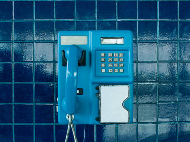 Public telephone booth A time when people were not so connected blue pay phone stock pictures, royalty-free photos & images