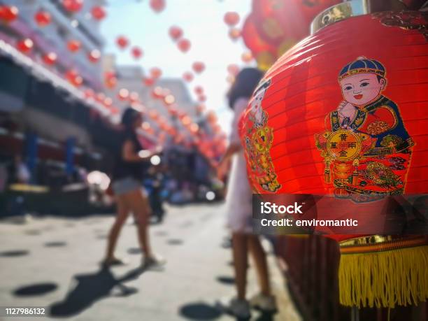 Colorful Chinese New Year Red And Gold Traditional Festival Lanterns Adorn Part Of The Famous Traditional Chiang Mai Worawot Market Near The River In Downtown Chiang Mai Whilst Tourists And Locals Pass Through The Street Admiring The Decorations Stock Photo - Download Image Now