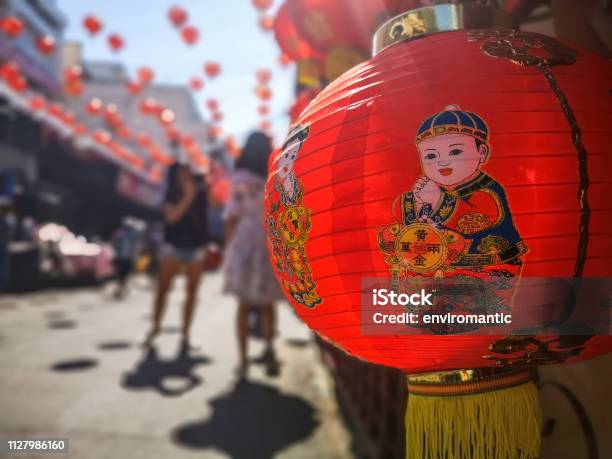 Colorful Chinese New Year Red And Gold Traditional Festival Lanterns Adorn Part Of The Famous Traditional Chiang Mai Worawot Market Near The River In Downtown Chiang Mai Whilst Tourists And Locals Pass Through The Street Admiring The Decorations Stock Photo - Download Image Now