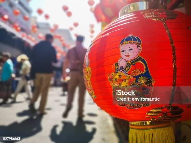 Colorful Chinese New Year Red And Gold Traditional Festival Lanterns Adorn Part Of The Famous Traditional Chiang Mai Worawot Market Near The River In Downtown Chiang Mai Whilst Tourists And Locals Pass Through The Street Admiring The Decorations Stock Photo - Download Image Now