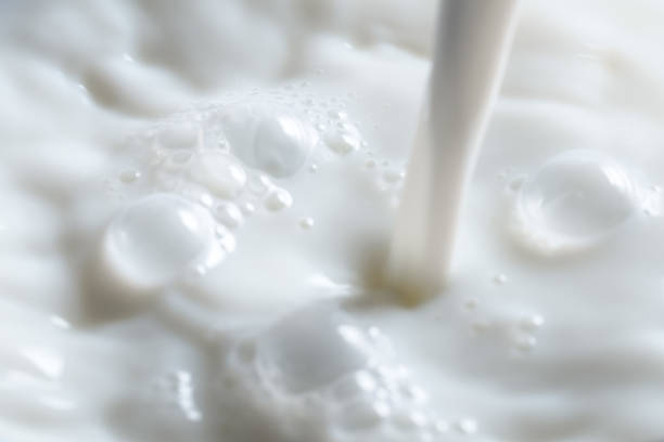 istock Pouring fresh milk into glass close up. 1127986367