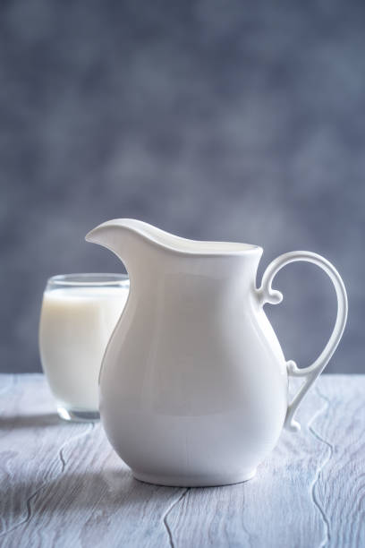 istock Pouring fresh milk into glass close up. 1127986368