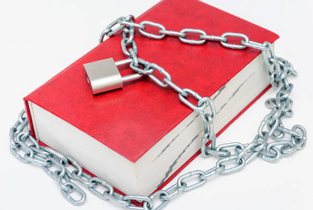 istock Large red book wrapped in a chain and locked 1127989287