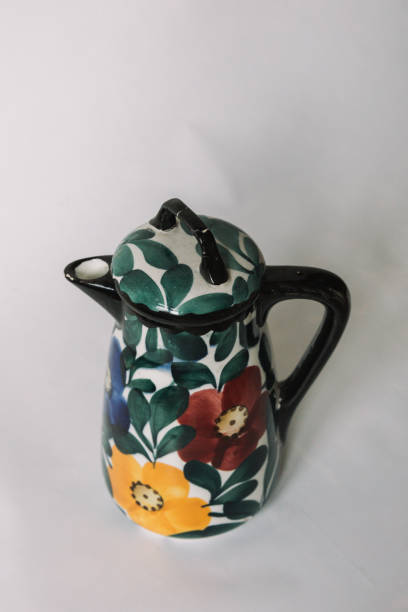 istock a white teapot  with floral and line pattern on white background 1127989933