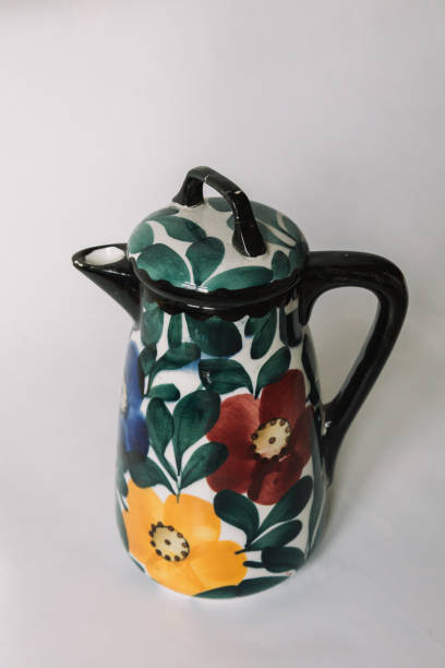 istock a white teapot  with floral and line pattern on white background 1127990035
