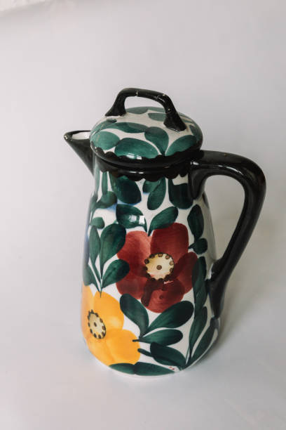 istock a white teapot  with floral and line pattern on white background 1127990384