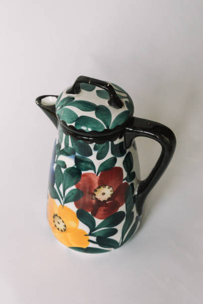 istock a white teapot  with floral and line pattern on white background 1127990486