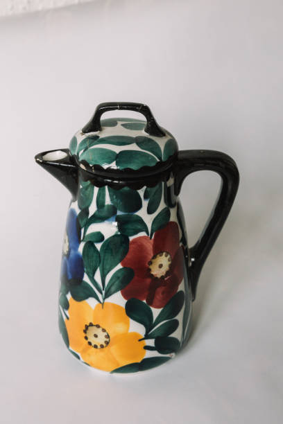 istock a white teapot  with floral and line pattern on white background 1127990672