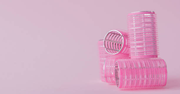 istock Curlers hair plastic on a pink background with copy space 1127991905
