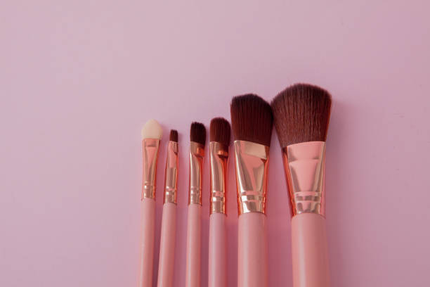 istock Set of makeup brushes on pink background. Flat lay 1127991926