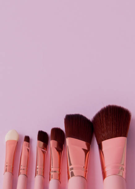 istock Set of makeup brushes on pink background with copy space. Flat lay 1127992649
