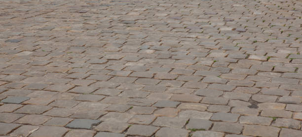 istock Abstract background of old cobblestone pavement close-up 1127995180