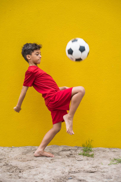 istock Little supporter playing soccer 1127997301