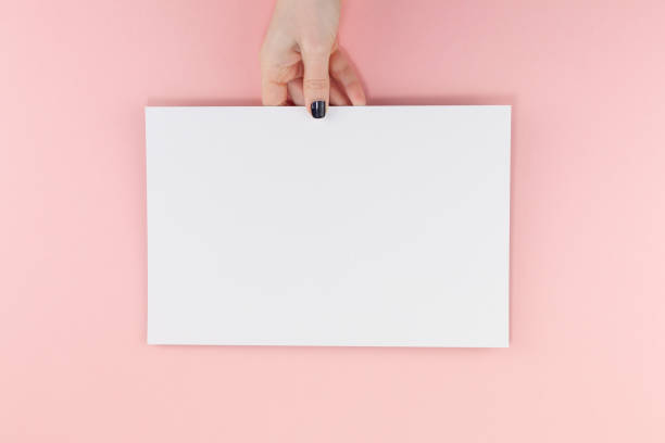 istock Woman hands with blank A4 paper sheet mockup 1127999638